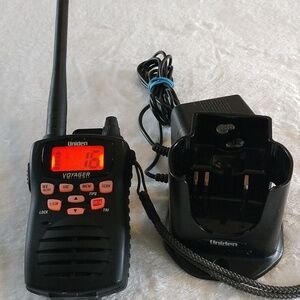 Uniden Voyager handheld VHF marine radio with its charging dock